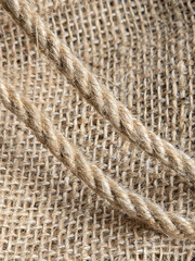 burlap - rough embossed texture of natural fabric with rope elements close-up background