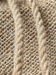 burlap - rough embossed texture of natural fabric with rope elements close-up background