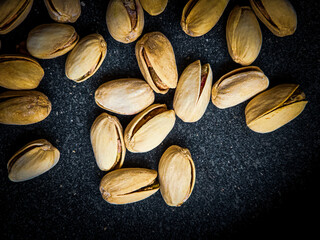 fresh and tasty pistachio nuts on the table, close up