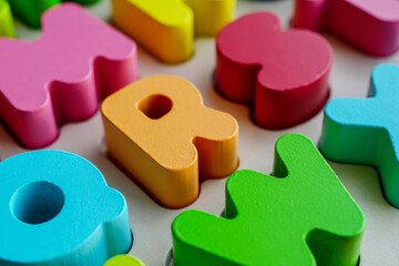 wooden educational letters, scattered letters create a background