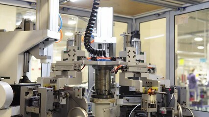 Intricate automated machinery in a vibrant manufacturing facility, showcasing advanced mechanical components and robotic systems. The dynamic environment highlights efficiency and safety
