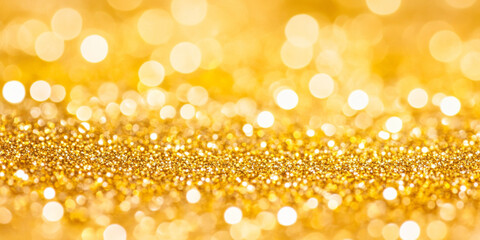 Abstract yellow glitter sparkle background with radiant golden hues. Defocused light enhances the shimmer and glowing bokeh effects.