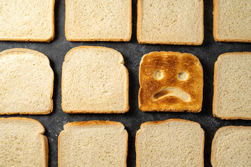 Gluten food, celiac disease, slice of toasted bread with sad face. Gluten sensitivty