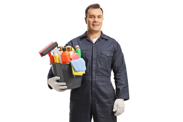 Male cleaner in a uniform posing with a bucket of cleaning supplies © Ljupco Smokovski