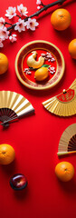 Obraz premium Vibrant red background with gold ingots, oranges, fans, and plum blossoms symbolize good fortune and luck for Chinese New Year festivities.