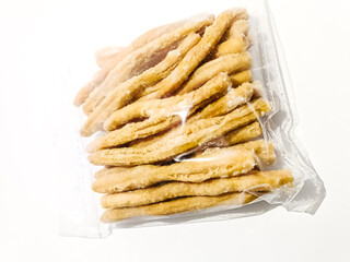 A clear plastic bag filled with crispy and crunchy traditional Malaysian snacks, coated with sugar for a sweet and satisfying treat. Perfect for snacking anytime and sharing with friends or family.