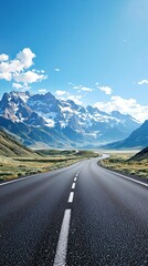 Naklejka premium A sweeping view of the mountains stretches along an empty asphalt road, mountain scenery, open landscape, natural beauty