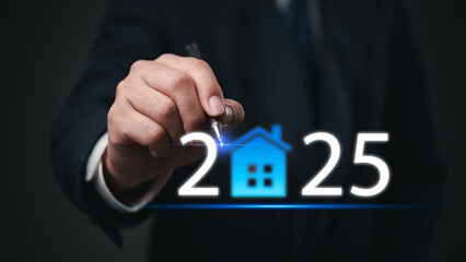 Businessman pointing at 2025 with a glowing house icon representing real estate growth and market...