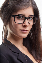 Obraz premium Young businesswoman wearing eyeglasses with serious expression