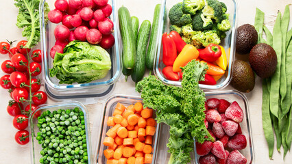 Boxes with fresh raw vegetables on table.