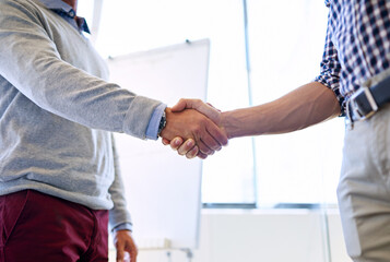 Fototapeta premium Business, man and handshake at office on workshop for partnership, deal and agreement. Closeup, people and employees with shaking hands for greeting, welcome and introduction for collaboration