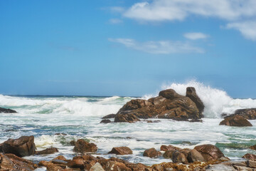 Outdoor, splash and ocean with rocks, waves and destination for travel getaway at sea. Island tourism, outside and beach with scenic nature or water for paradise or vacation adventure in Indonesia