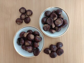 Shiny brown chestnuts on the table