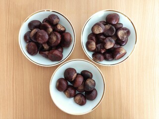 Shiny brown chestnuts on the table