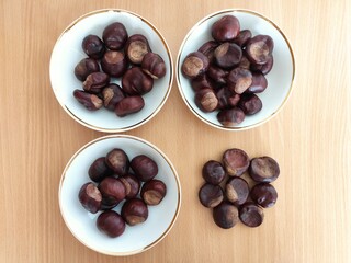 Shiny brown chestnuts on the table