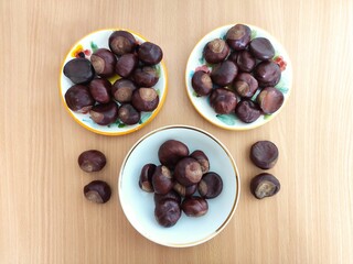 Shiny brown chestnuts on the table