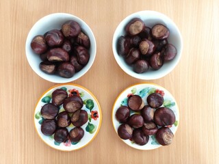 Shiny brown chestnuts on the table