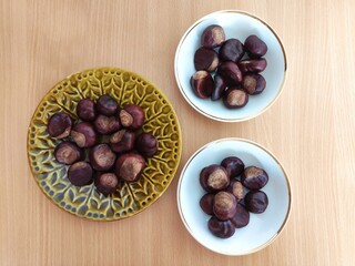 Shiny brown chestnuts on the table