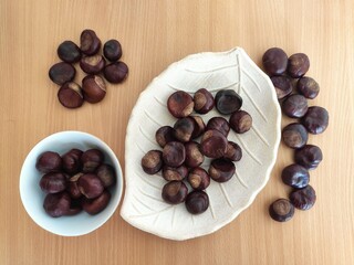 Shiny brown chestnuts on the table