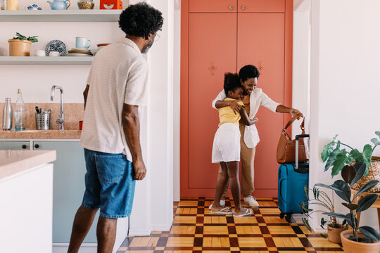 Little girl welcoming her mom home with a hug