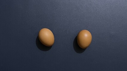 Two Brown Eggs on a Dark Surface: A Simple Minimalist Still Life Photography