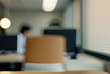 Blurred office worker. Abstract image of a person working, conveying privacy, anonymity, and the everyday office routine.