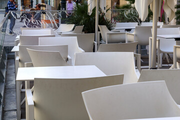 
outdoor cafe in the city with served tables for customers