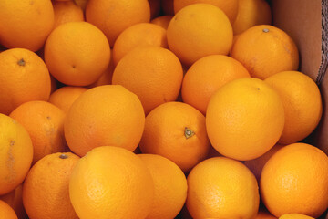 
a pile of oranges stacked in the market