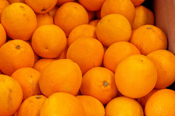 
a pile of oranges stacked in the market
