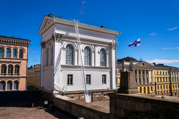 Finnish coat of arms on national flag in front of Helsinki cathedral on the Senate square