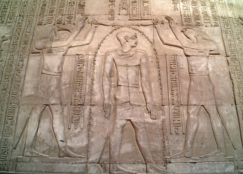 Wall relief of the gods Thoth and Horus flanking a Pharoah, Kom Ombo Temple Egypt
