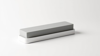 Sharpening stone for kitchen knives. A sharpening stone with a gray surface and black base on a white background, ideal for honing blades and maintaining their sharpness.