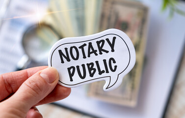Woman in a White shirt holds a piece of paper with the text Notary Public, business concept