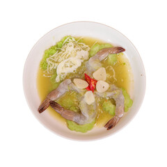A plate featuring shrimp on a bed of lettuce, garnished with garlic, chili, and a light broth.