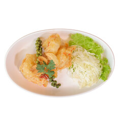 A plate of golden fried shrimp garnished with fresh greens and herbs, served with shredded cabbage.
