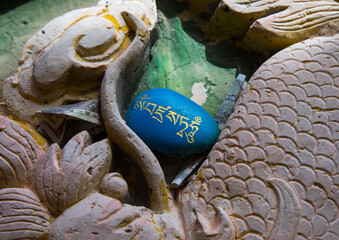 Tibetan religious budhist symbols carved on stones in Shachong monastery, Qinghai Province, Wayaotai, China