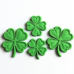 Fototapeta premium Four vibrant green shamrock shapes, varying in size, symbolize luck and St. Patrick's Day celebrations.isolate on white background