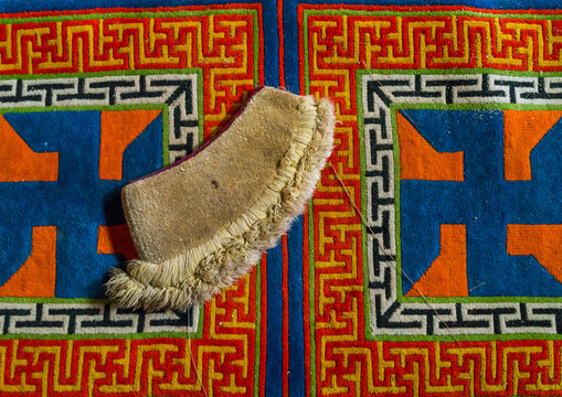 Yellow hat sect on a carpet with swastikas inside Bongya monastery, Qinghai province, Mosele, China