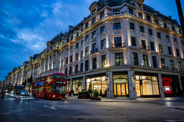 double decker red double autobus in London center at evening with classic beautiful buildings and...