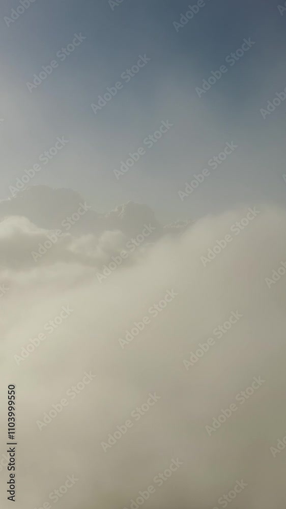 Wall mural flying above the clouds. aerial view of clouds at sunrise. traveling by air perfect background. vert