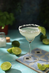 A glass with margarita cocktail with lime