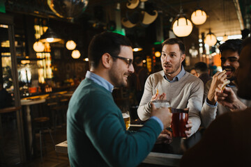 Group of friends have beer time in pub
