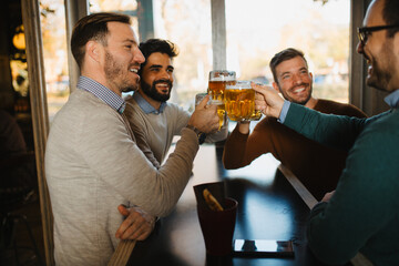 Group of friends have beer time in pub