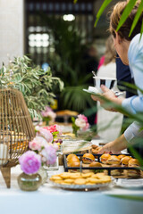Businesswoman  with a cup of coffee  gathering food from a buffet table