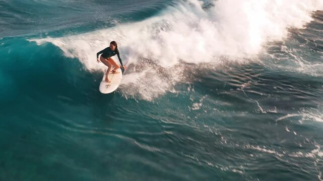Wave surfing aerial. Woman surfs the wave in the Maldives
