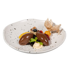A visually appealing dessert featuring chocolate mousse, garnished with fruits and a delicate pastry.