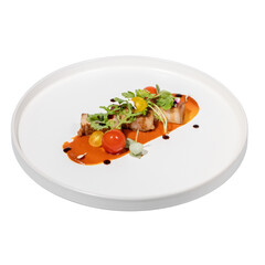 A gourmet dish featuring grilled meat, assorted cherry tomatoes, and fresh greens drizzled with sauce on a round white plate.
