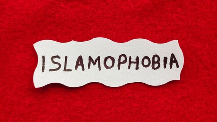 Islamophobia word letters text handwritten calligraphy design on white paper label note isolated on...