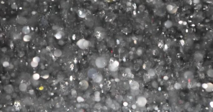 Silver sequins catch light creating party atmosphere. Holographic glittering background from confetti. Concept of festive celebration