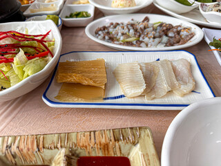 Korean food. Skate sashimi and white kimchi